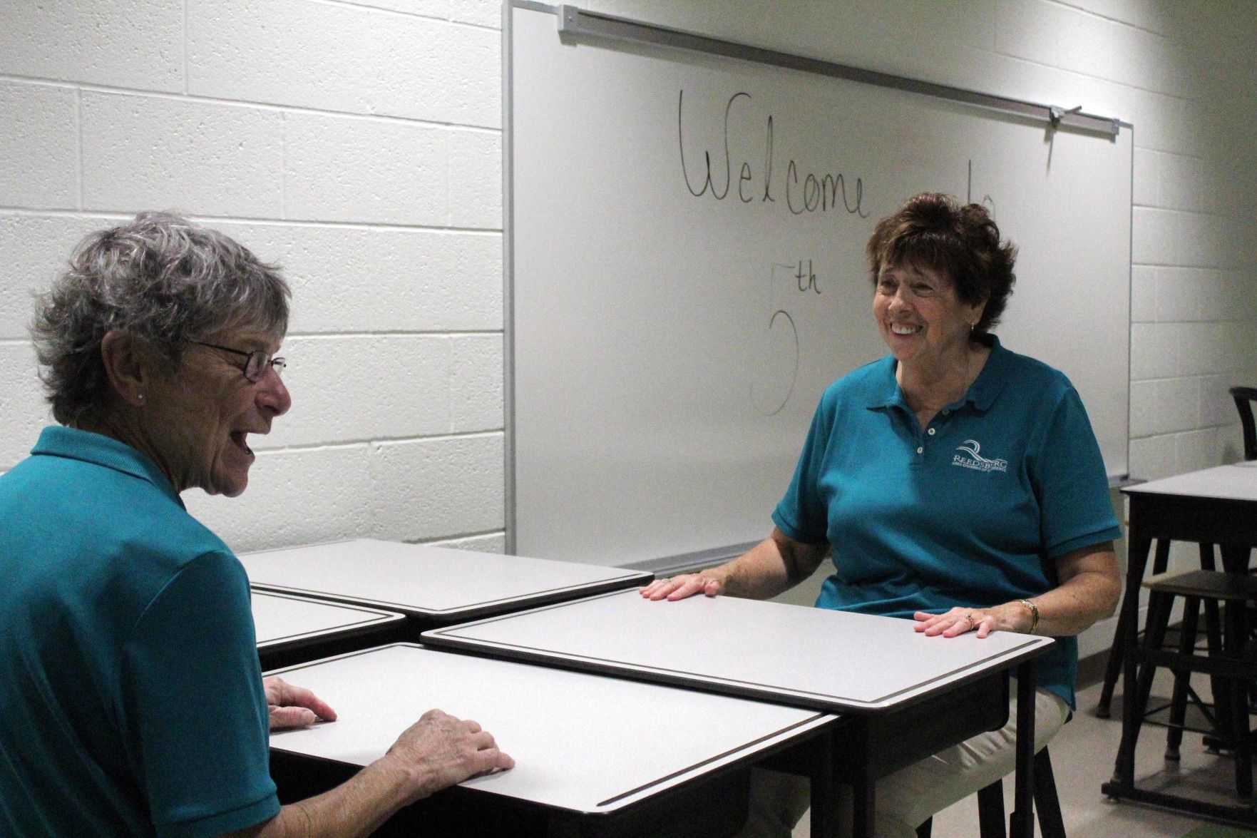 Jarleth and Sue sit at tables